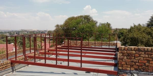 A wooden deck frame with its railing